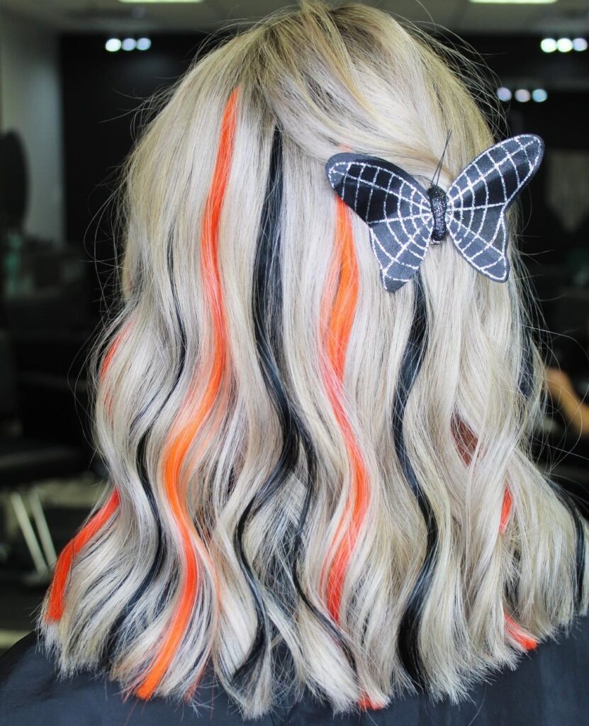 10 Spooky Halloween Hair Colors to Try This Year 2 Orange and Black Streaks