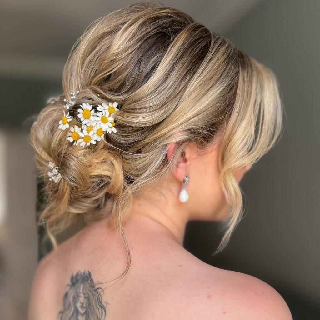 12 Best Wedding Hairstyles in 2025: From Chic Updos to Flowing Waves 1 Romantic Floral Low Bun