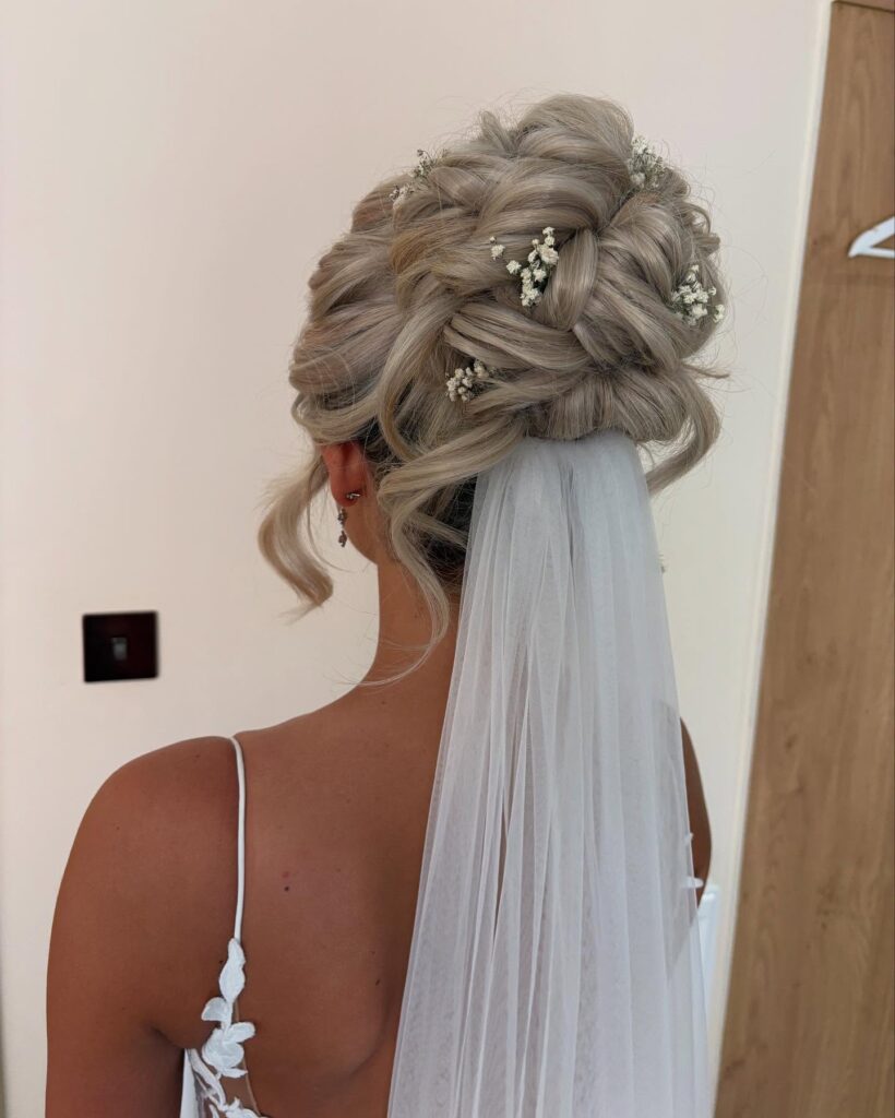 12 Best Wedding Hairstyles in 2025: From Chic Updos to Flowing Waves 6 Textured Updo with Veil